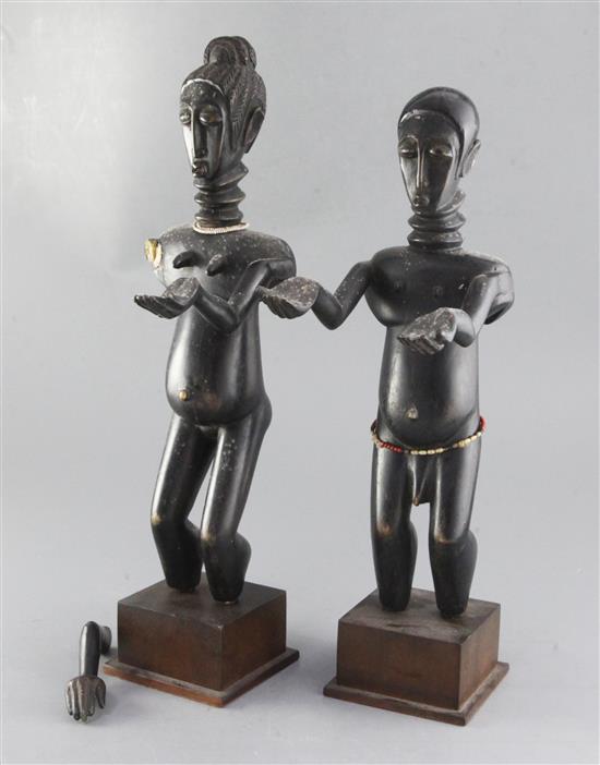 A pair of African ebonised wood figures of a man and woman